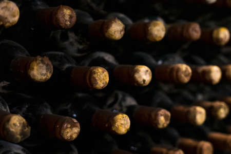 Wine bottles are aged in a dark cellar or basement. Backgroundの写真素材
