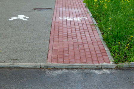 Marking on paving slabs in the form of an abstract man. Pedestrian area on the combined sidewalk with a bike path. Abstract backgroundの写真素材