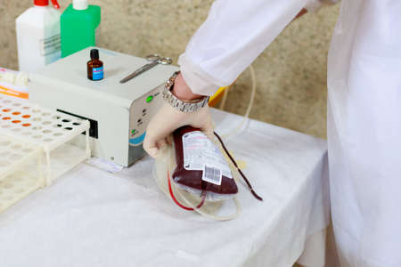 Transparent vacuum medical blood bags. Public event for blood donor day. Background with copy space for text or lettering. Illustrative editorial. June 13, 2021, Balti Moldova.のeditorial素材