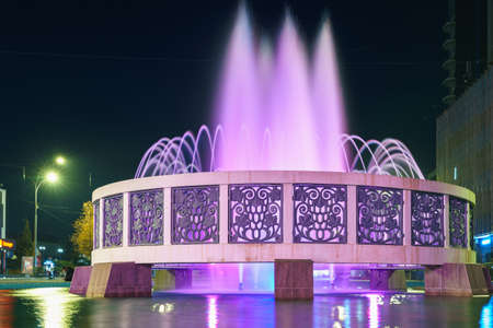 Central city fountain illuminated at night. The most recognizable tourist sight of the city. Background with copy space for text. Illustrative editorial. October 22, 2021 Balti Moldova.のeditorial素材
