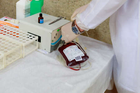 Transparent vacuum medical blood bags. Public event for blood donor day. Background with copy space for text or lettering. Illustrative editorial. June 13, 2021, Balti Moldova.のeditorial素材