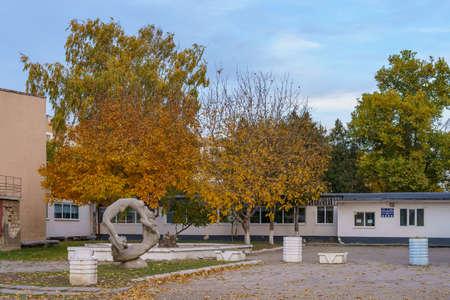 A monument to athletes surrounded by an autumn small town. Background with copy space for text. Illustrative editorial. October 21, 2021 Balti Moldova.のeditorial素材