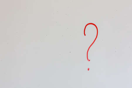 Question mark on an old white magnetic board in the office. Background with copy space for text or letteringの写真素材
