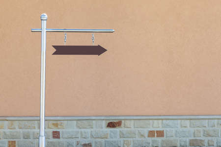 Arrow on a pillar with copy space for text or inscription. Background or blank for design.