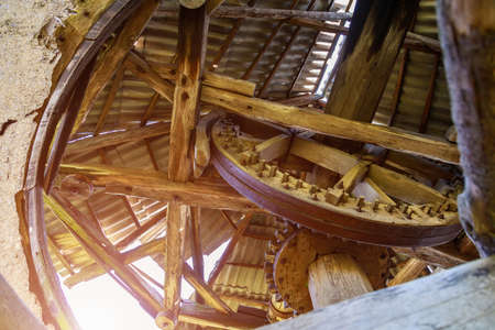 Wooden gears retro vintage abandoned windmill. An ancient flour mill. Background with copy space for...