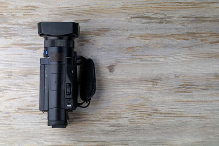 Handicam or a small handheld video camera is on the table. Tool operator or a journalist. Background with copy space for text. Illustrative editorial. September 3, 2021 Balti Moldova.のeditorial素材