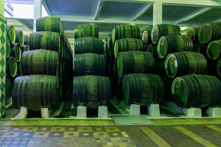 Dark cellar with barrels for aging luxury alcohol. Illustrative editorial. October 1, 2021 Balti Moldova.のeditorial素材