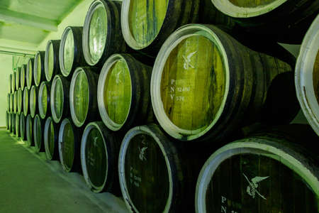 Dark cellar with barrels for aging luxury alcohol. Illustrative editorial. October 1, 2021 Balti...