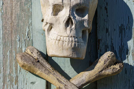 Wooden vintage human skull symbol. Background with copy space for text or letteringの写真素材