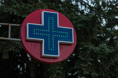 Cross pharmacy symbol on a background of a beautiful sky with a place for text or inscriptions.の写真素材