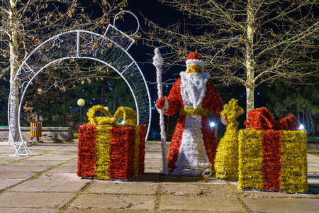 Decorative Santa Claus with gifts, made of Christmas tinsel. Background with copy spaceの写真素材