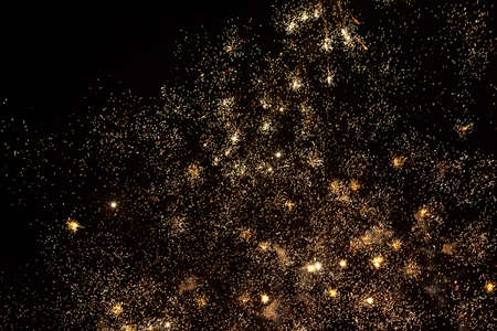 Fireworks sparks on a black sky background with copy space for text or inscriptions. A graphic resource for design. Blank for the designer. Underlay or undercoat.の写真素材