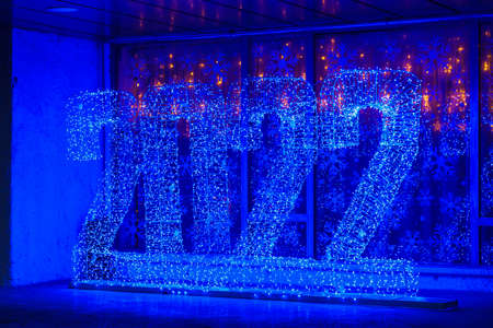 Glowing street Christmas or New Year garland in the form of numbers 2022. Background with copy space for text or inscriptionの写真素材