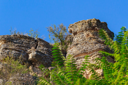 Wild rocky and mountainous nature of Eastern Europe. Landscape background with copy space for text. Selective focus, toned. The village of Tipovo or Tipova, welcome to Moldova.の写真素材