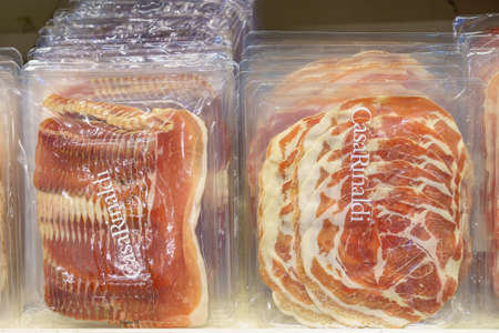 December 2, 2021 Balti Moldova. Illustrative editorial. Supermarket showcase with prosciutto crudo. Background with copy space for text or inscriptions.のeditorial素材