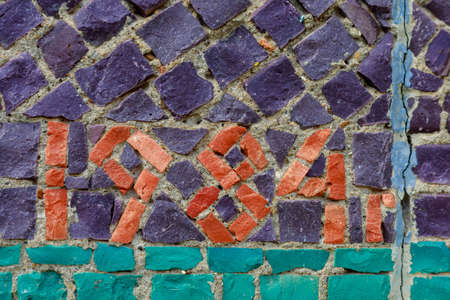 Mosaic elements in the old historical architecture of the urban environment. Rough textured background with copy space for text or lettering. Underlay blank or graphic design resourceの写真素材