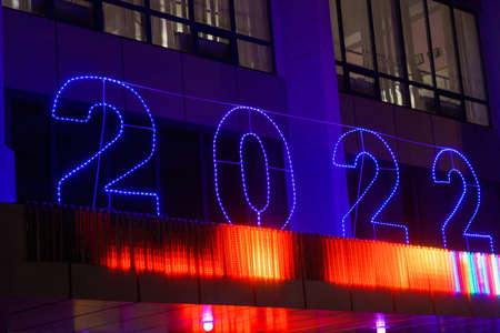 Glowing street Christmas or New Year garland in the form of numbers 2022. Background with copy space for text or inscriptionの写真素材