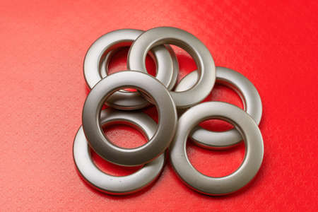 Matte eyelets for curtains on a bright colored background. Decor element for creating home comfort in interior design. Selective focusの写真素材