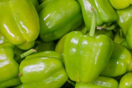 Farm organic green bell pepper. Natural vitamins in a retail grocery store. Selective focus with...