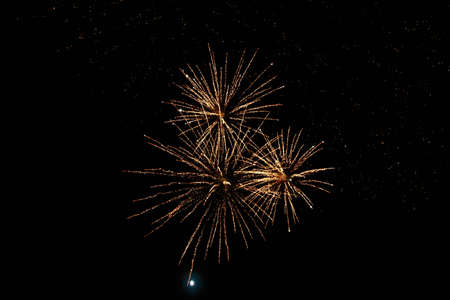 Very beautiful fireworks against the black sky with copy space for text or inscriptions. A graphic...