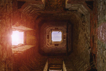 Old vintage ruined abandoned tower. Ruins of historical heritage. Travel background with copy space for text.の写真素材