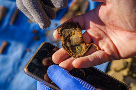 Retro remains of a purse with coin prints. Archaeological excavations of criminologists for...