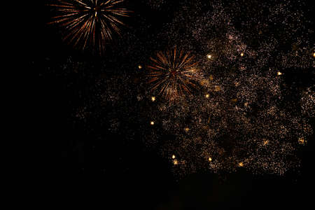 Fireworks sparks on a black sky background with copy space for text or inscriptions. A graphic resource for design. Blank for the designer. Underlay or undercoat.の写真素材