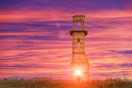 Old vintage ruined abandoned tower. Ruins of historical heritage. Travel background with copy space...