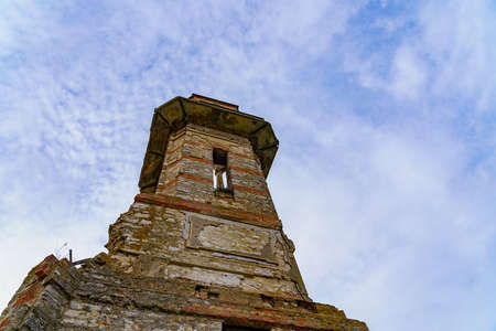 Old vintage ruined abandoned tower. Ruins of historical heritage. Travel background with copy space for text.の写真素材