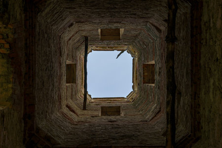 Old vintage ruined abandoned tower. Ruins of historical heritage. Travel background with copy space...