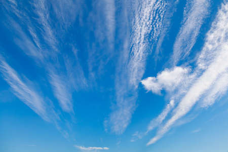 Beautiful blue sky with clouds in windy weather. Background or backdrop for design. Graphic resource blank for the designer.の写真素材