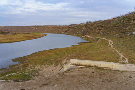Decreasing river Reut in Moldova. Disappearing rivers and drying up reservoirs. Problems of the ecology of the planet. Global warming and climate change. Background with copy space for textの写真素材