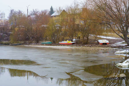 Catamaran on a frozen river in winter. Background with copy space for textの写真素材