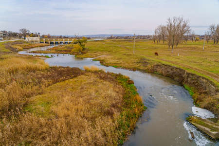 An old abandoned hydroelectric power station on a small river. Apocalyptic background with copy space for text.の写真素材