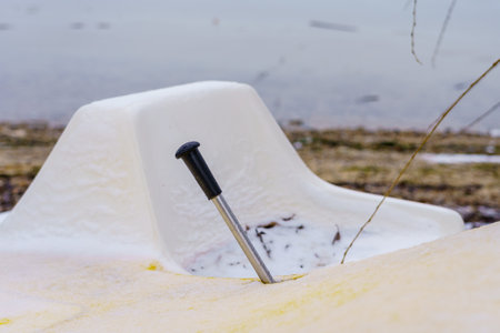 Lever of a catamaran on a frozen river in winter. Background with copy space for textの写真素材