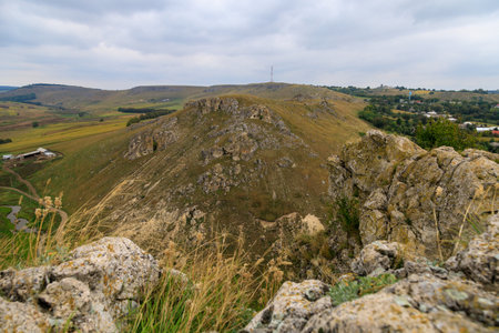 Wild rocky and mountainous nature of Eastern Europe. Landscape background with copy space for text. Selective focus, toned. Corjeuti village, welcome to Moldova.の写真素材