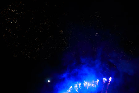 Fireworks sparks on a black sky background with copy space for text or inscriptions. A graphic resource for design. Blank for the designer. Underlay or undercoat.の写真素材