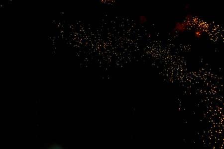 Fireworks sparks on a black sky background with copy space for text or inscriptions. A graphic...
