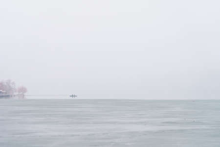 Foggy bank of a river or reservoir in damp cold weather. Background with copy space for textの写真素材