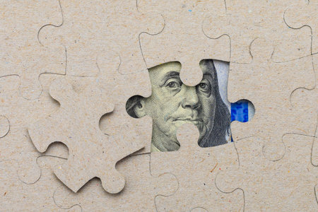 Missing puzzle piece and framed US dollars. Background with copy space for textの写真素材