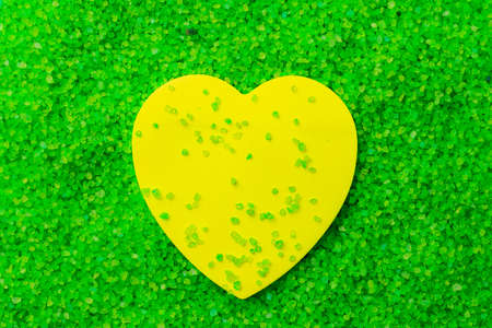 Paper sticker in the shape of a heart on the background of sea aromatic bath salts. The concept of...