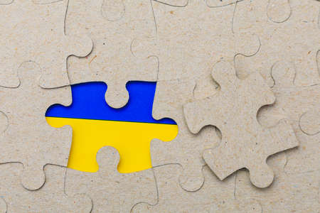 The missing piece of the puzzle and the flag of Ukraine in the frame. Background with copy space for...