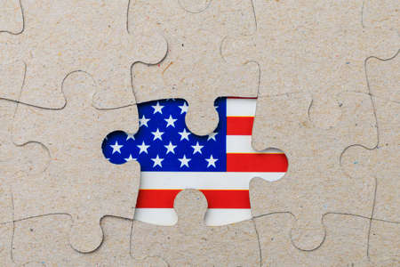 Missing puzzle piece and framed US flag. Background with copy space for textの写真素材