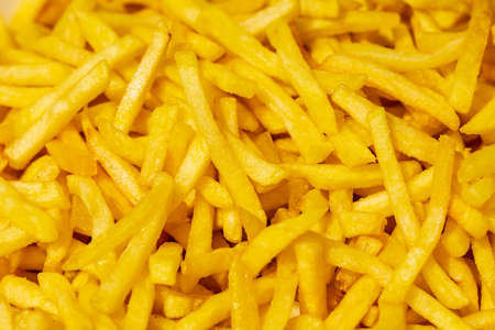 Close up of fried french fries for sale at the international street food festival, selective focus....