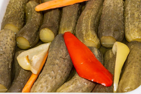 Close up of pickled cucumbers for sale at the international street food festival, selective focus. Background. Vegetarian cuisine. Marinated pickles.の写真素材