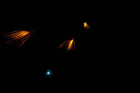 Fireworks sparks on a black sky background with copy space for text or inscriptions. A graphic...
