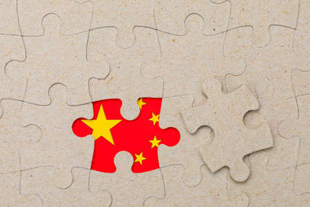 The missing piece of the puzzle and the flag of China in the frame. Background with copy space for textの写真素材