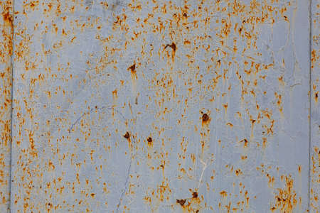 Peeling cracked paint on a metal surface. Texture background or backdrop for design