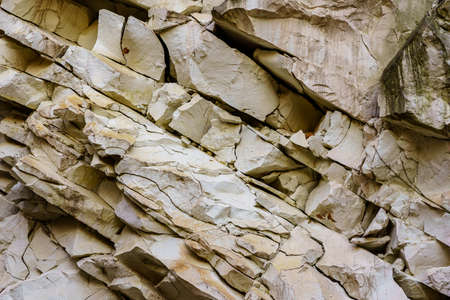 Texture cracked rock formation rock in the wild. Background with copy space for text