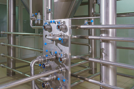 A stainless steel pipe system in the food industry at a brewery in the process of brewing beer....